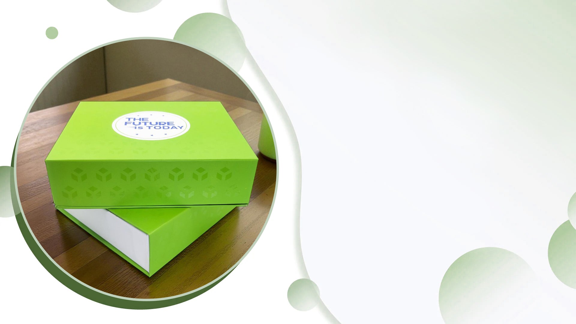 Green gift box with a white label on a wooden surface