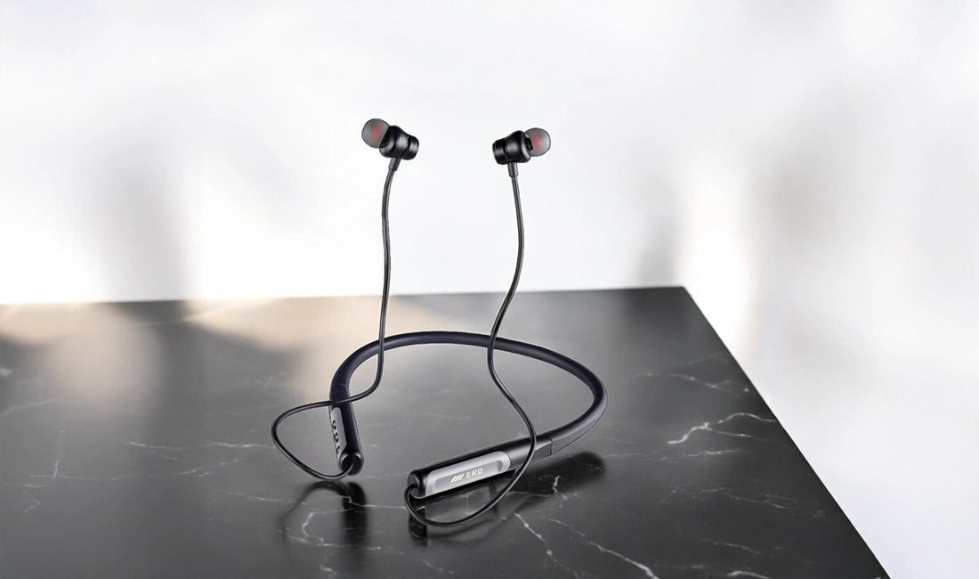 Wireless earbuds with charging case on a black marble surface